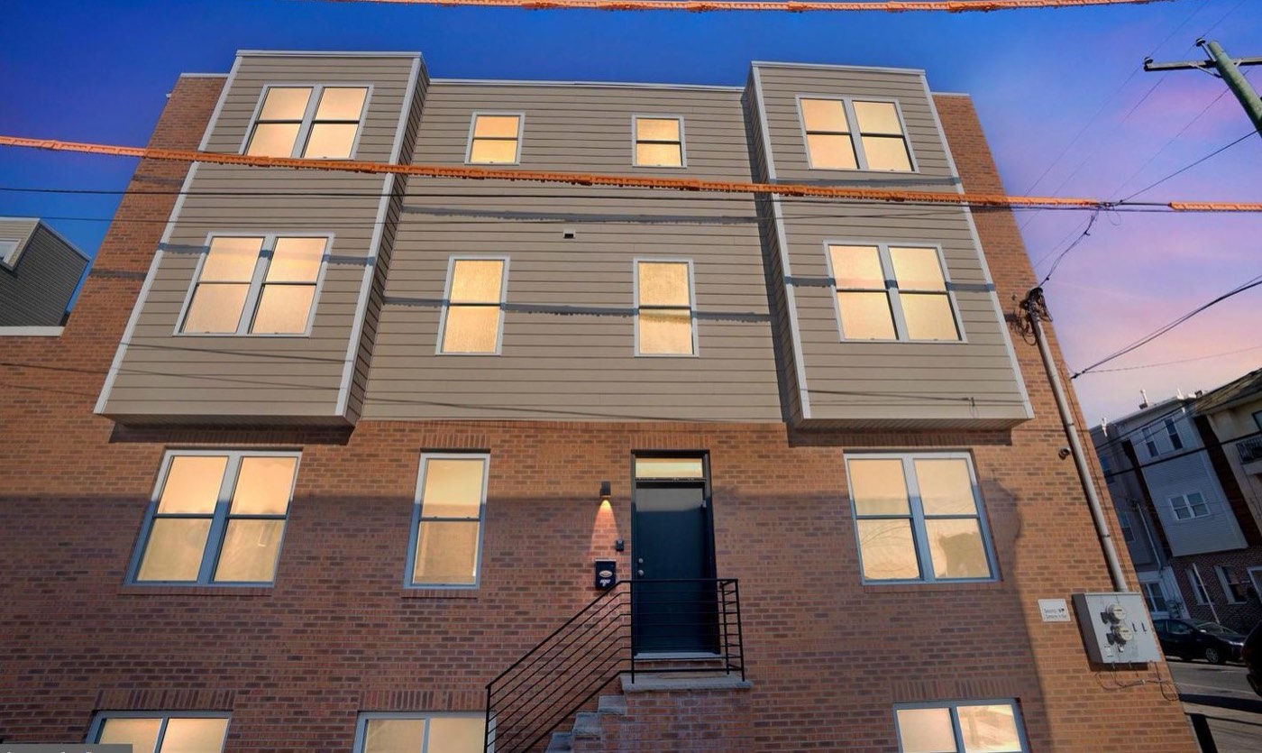 2126 S 4th St at twilight, new three-story brick construction