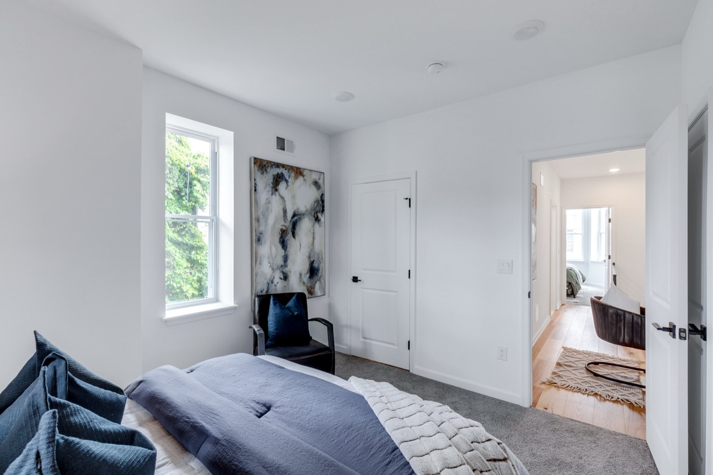 Staged navy bedroom at 710 S Frazier St after renovation