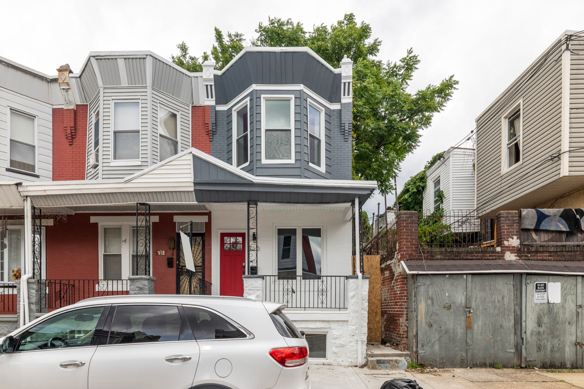 710 S Frazier St after renovation, gray facade with a red front door