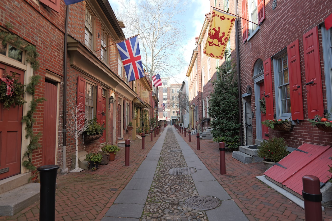 Historic cobblestone street lined with red brick rowhouses in Philadelphia