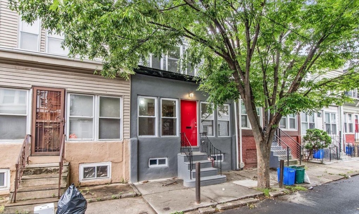 1526 S Vogdes St after renovation, gray facade with a red front door